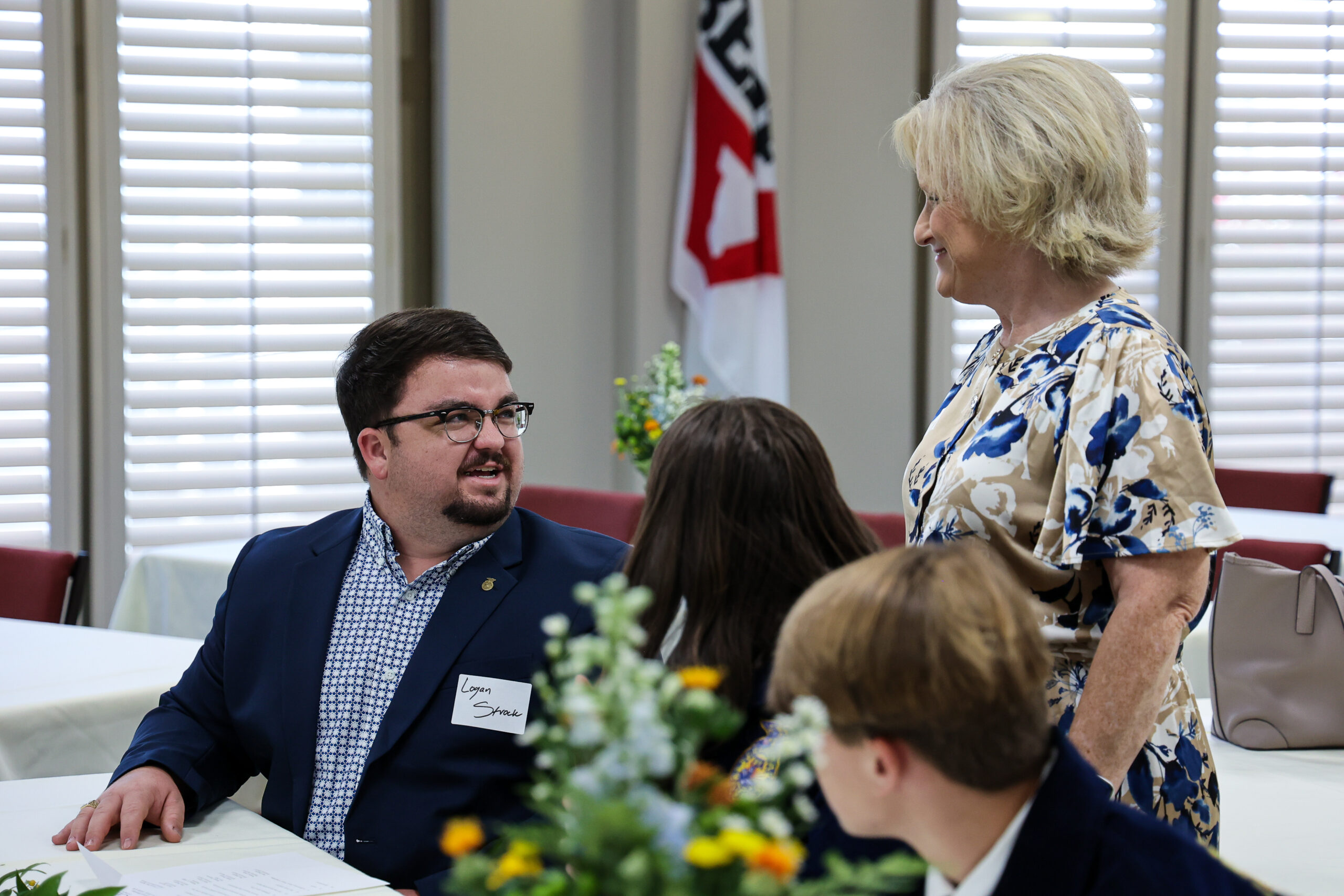 Exectutive Director Pam Hughes speaks with Billingsley teacher Logan Strock