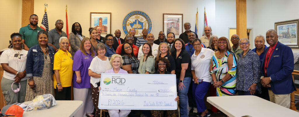 $104,801.25 RC&D check presentation group photo inside governmental room.