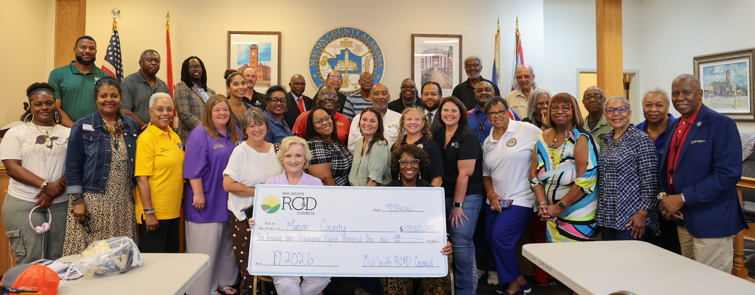 $104,801.25 RC&D check presentation group photo inside governmental room.
